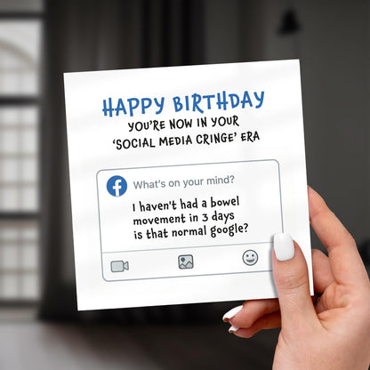 Hand holding a birthday card with humorous social media reference