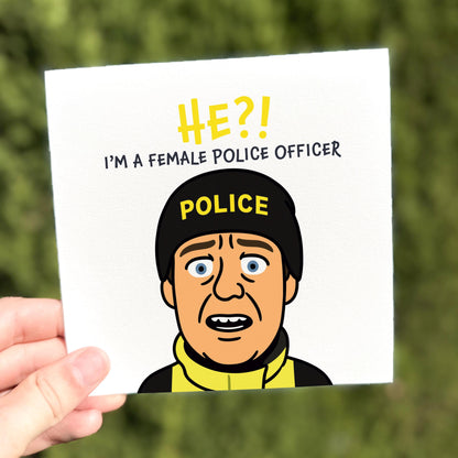 Card with a cartoon character wearing a police helmet and text about a female police officer, held against a blurred green background.