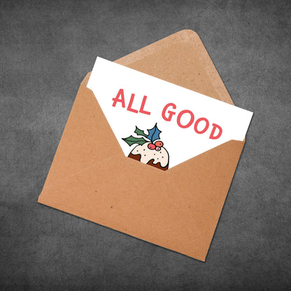 Brown envelope with a card inside displaying 'ALL GOOD' text and a Christmas-themed illustration.