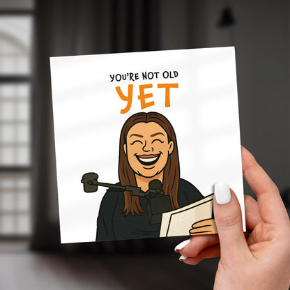 Card with a judge illustration and text 'You're not old YET' held by a hand.