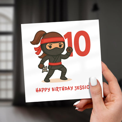 Birthday card with a cartoon ninja character and the number 10, held by a hand.