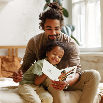 Man and child reading a book together in a cozy room