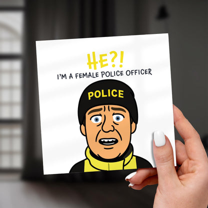 Card with a cartoon character in a police uniform and text about a female police officer, held by a hand.