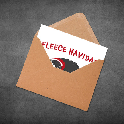 Open brown envelope with a white card inside displaying 'FLEECE NAVIDAD' text.