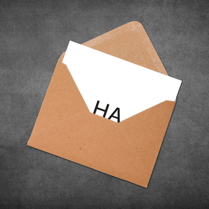 Brown envelope with a white card inside displaying the word 'HA' on a gray background