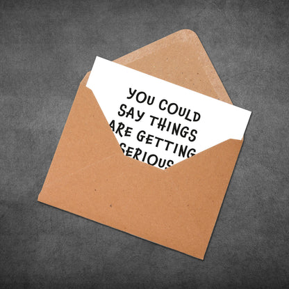 Brown envelope with a white card inside displaying text on a gray background