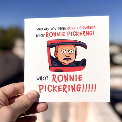 Card with cartoon character and text 'Who are you then? Ronnie Pickering! Who? Ronnie Pickering!!!' held by a hand.