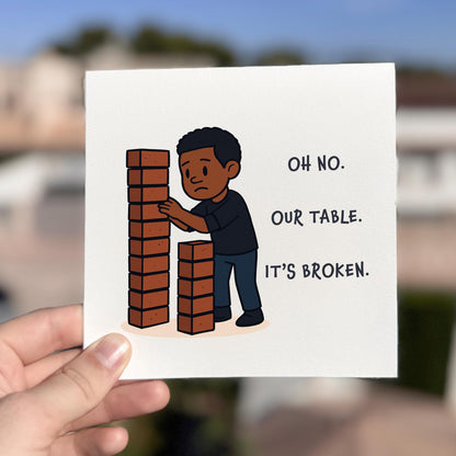 Card with illustration of a person building a wall with bricks and text 'Oh no. Our table. It's broken.'