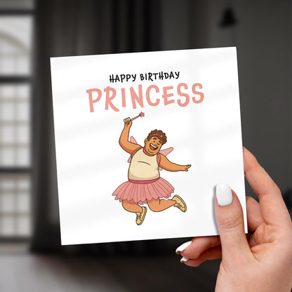 Hand holding a birthday card with a cartoon character and 'Happy Birthday Princess' text.