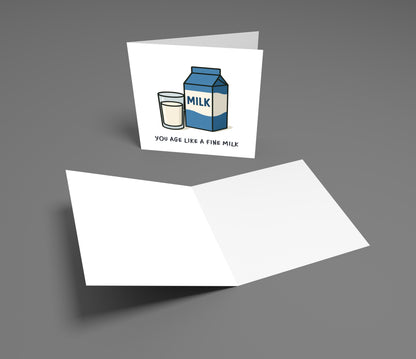 Greeting card with milk carton and glass illustration and humorous text on a gray background