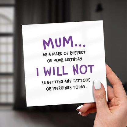 Hand holding a card with humorous birthday message for mum