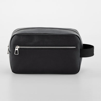 Black toiletry bag with a silver zipper on a light gray background