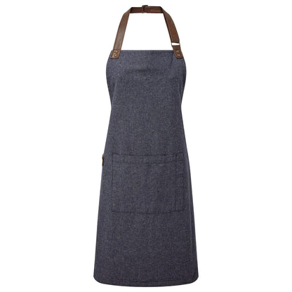 Blue denim apron with brown leather straps on a white background