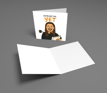 Greeting card with a humorous illustration and text on a gray background