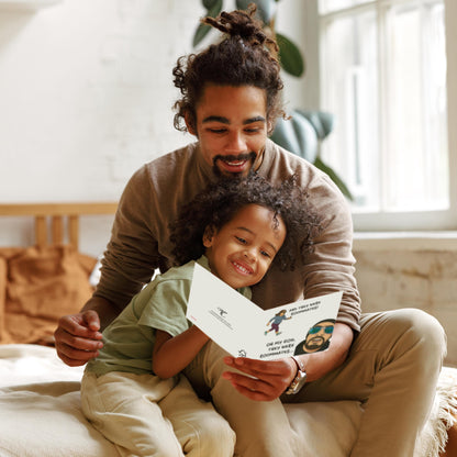 Man and child sitting together, looking at a piece of paper in a bright room.