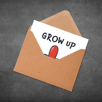 Open brown envelope with a card inside that says 'GROW UP' on a dark gray background