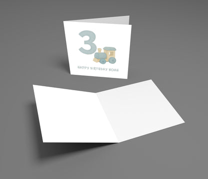 Greeting card with number 3 and train design on a gray background