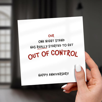 Hand holding a card with humorous anniversary message.