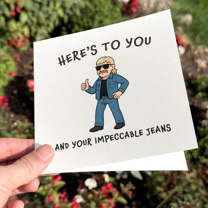 Card with a cartoon character and text about jeans held in front of a blurred natural background.