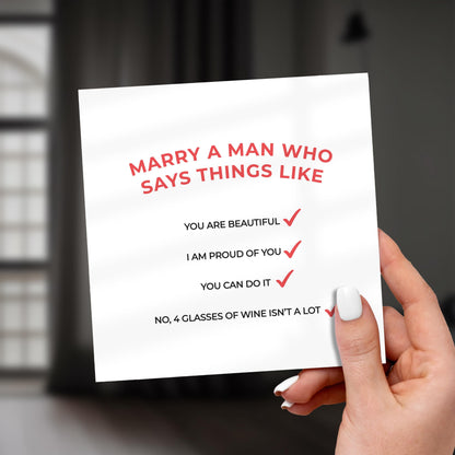 Hand holding a card with romantic message and checkmarks.