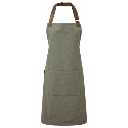 Green apron with brown leather straps on a white background
