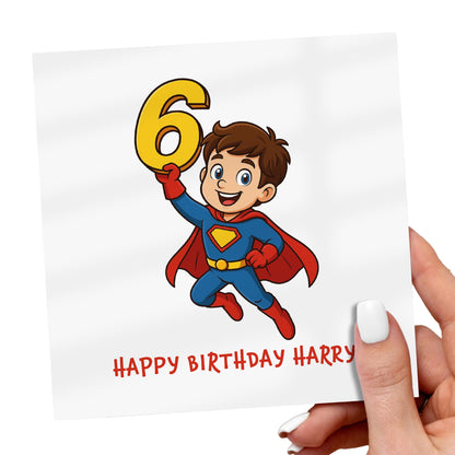 Superhero-themed birthday card with a child holding up the number 6, personalized with 'Happy Birthday Harry'.