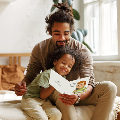 Man and child sitting together, reading a book indoors.