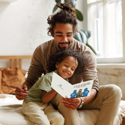Man and child sitting together, reading a book in a cozy room.