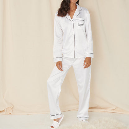 White pajama set with 'Bella Freud' branding worn by a model on a beige background