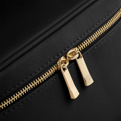 Close-up of a gold zipper on a black background