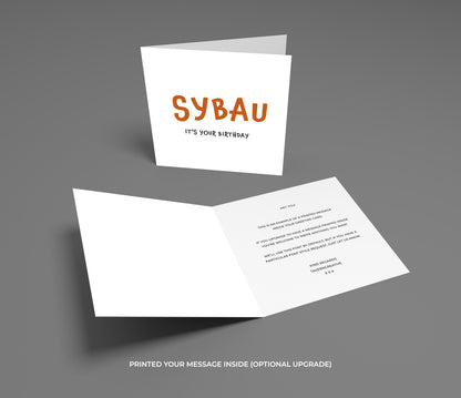 Greeting card with 'SYBAU' and 'It's your birthday' text on a gray background