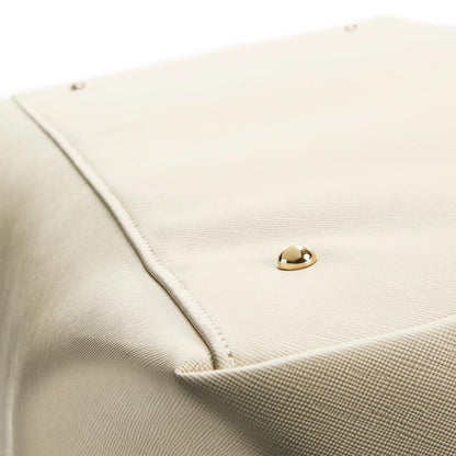 Close-up of a beige fabric with a gold button on a white background