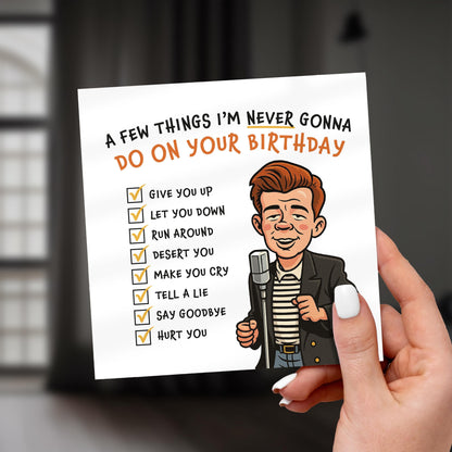 Hand holding a card with a humorous birthday message and cartoon character.