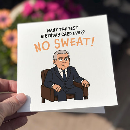 Birthday card with cartoon character and humorous text, held by a hand with a blurred floral background.