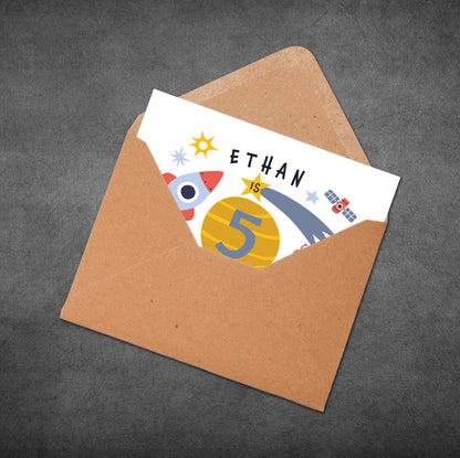 Card with 'Ethan is 5' on a brown envelope against a dark gray background