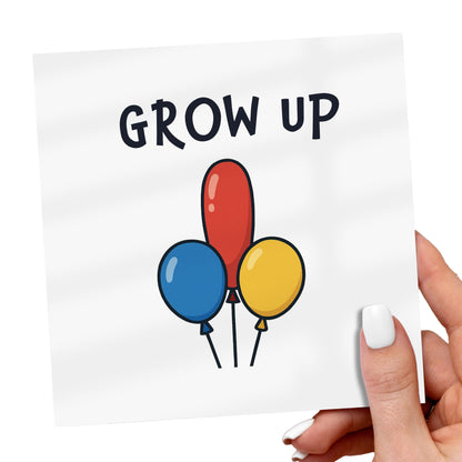 Card with 'GROW UP' text and colorful balloons held by a hand.