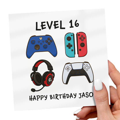Birthday card with gaming-themed illustrations and text, held by a hand.