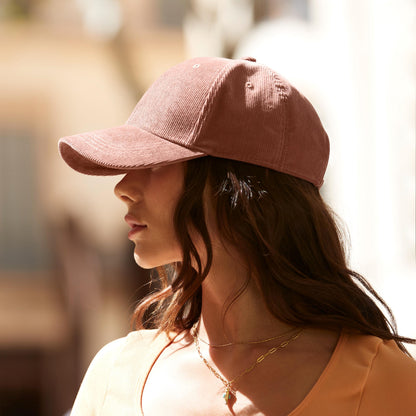 Woman wearing a pink cap with a blurred background