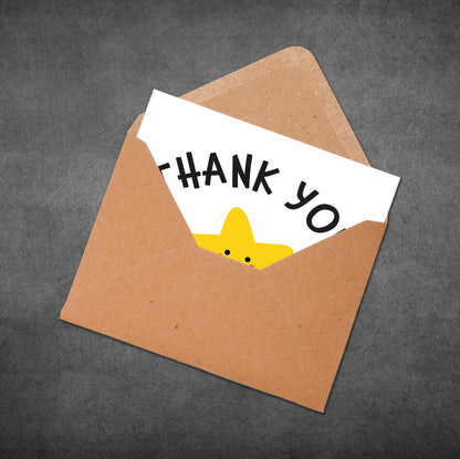 Brown envelope with a white card inside that says 'THANK YOU' with a yellow duck illustration on a dark gray background.