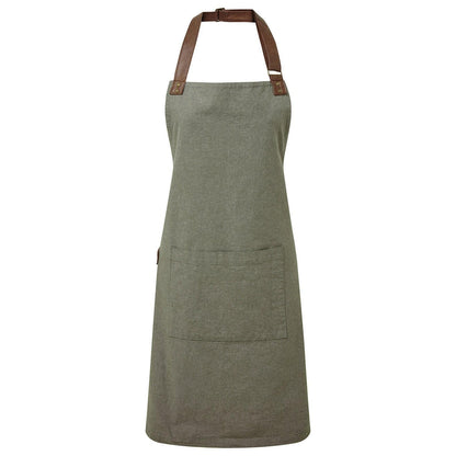 Green apron with brown leather straps on a white background