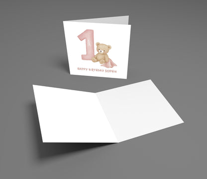 Birthday card with teddy bear and number one on a gray background