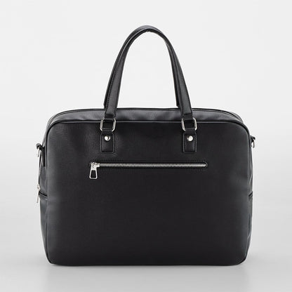 Black handbag with zippers on a light gray background