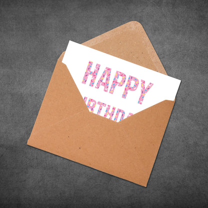Brown envelope with a 'Happy Birthday' card on a dark gray background