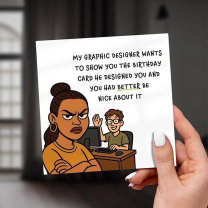 Cartoon birthday card held by a hand with text and illustration of a graphic designer and client.