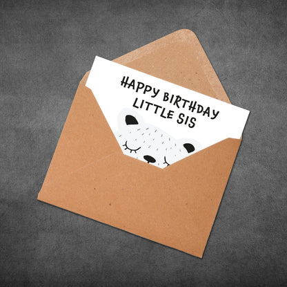 Brown envelope with a birthday card inside on a gray background