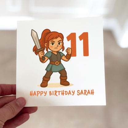 Birthday card with a character holding a sword and text 'Happy Birthday Sarah' on a white background.