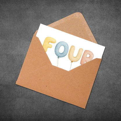 Brown envelope with a card inside displaying colorful balloons spelling 'FOUR' on a dark gray background