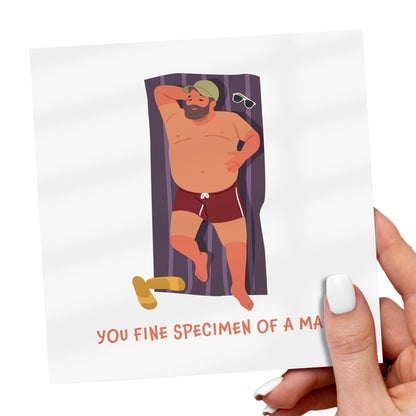 Cartoon character on a card with text, held by a hand.
