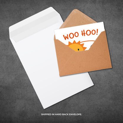 Greeting card with 'WOO HOO!' text and dinosaur graphic in a brown envelope on a gray background.