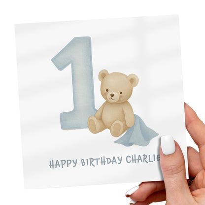 Card with a teddy bear and number '1' on a white background